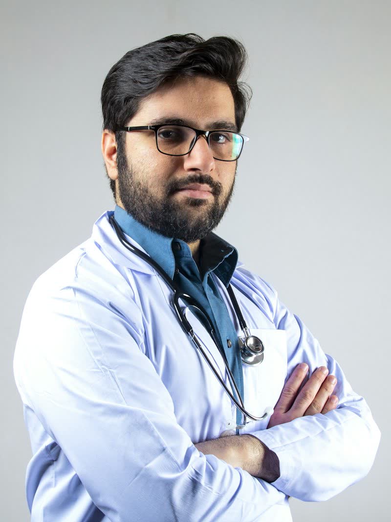 A doctor in a white coat with glasses